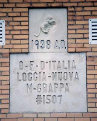 Inscription on the front of the Monte Grappa building in Colver.